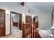 Hallway with wood trim, wood railing, and neutral carpet at 925 N Emerson St, Denver, CO 80218