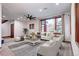 Bright living room featuring large windows, plush seating, and modern ceiling fan at 925 N Emerson St, Denver, CO 80218