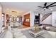 Open-concept living room with fireplace and elegant dining area with hanging lights at 925 N Emerson St, Denver, CO 80218