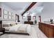 Spacious primary bedroom featuring a wet bar, wood beams, and carpet floors at 925 N Emerson St, Denver, CO 80218
