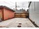 Spacious parking area featuring concrete pavement and a rustic wood gate, offering secure off-street parking at 925 N Emerson St, Denver, CO 80218