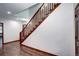 A bright staircase with wood railing adjoins gleaming hardwood floors in the home's interior at 925 N Emerson St, Denver, CO 80218