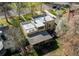 Aerial view of a home with a rooftop deck, patio, and mature trees at 2838 Forest St, Denver, CO 80207