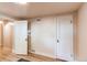 Neutral basement room showing two doors and plank flooring at 2838 Forest St, Denver, CO 80207