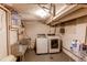 Basement laundry room with washer, dryer and large utility sink at 2838 Forest St, Denver, CO 80207