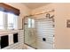 Bathroom showcases black and white tile, updated shower and shower door, with natural light at 2838 Forest St, Denver, CO 80207