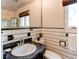 Bathroom boasts a dark granite countertop and black and white accents with a tiled shower at 2838 Forest St, Denver, CO 80207