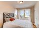 This spacious bedroom with large windows and white curtains is well-lit and move-in ready at 2838 Forest St, Denver, CO 80207
