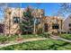 Brick home with a well-manicured lawn, garden and covered front porch at 2838 Forest St, Denver, CO 80207