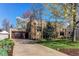 Home featuring a lush front lawn, large trees, and a two-car garage at 2838 Forest St, Denver, CO 80207