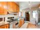 Traditional kitchen with light wood cabinets, stainless steel appliances, and hardwood floors at 2838 Forest St, Denver, CO 80207