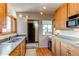 Charming kitchen featuring stainless steel sink, wood cabinets and a pass-through to dining area at 2838 Forest St, Denver, CO 80207