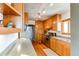 Bright kitchen with wood cabinets, stainless steel appliances, and hardwood floors at 2838 Forest St, Denver, CO 80207