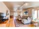 Spacious living room with hardwood floors, fireplace, and large windows at 2838 Forest St, Denver, CO 80207