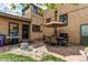 Inviting brick patio with a dining set, grill, and a peaceful outdoor lounge area at 2838 Forest St, Denver, CO 80207