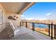 Spacious covered deck with seating overlooking scenic water views and mountains at 12371 Red Fox Way, Broomfield, CO 80021