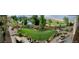 Expansive backyard oasis featuring lush landscaping, a fire pit, and a serene pond view at 12371 Red Fox Way, Broomfield, CO 80021