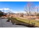 Well-maintained backyard with a lush lawn, brick retaining wall, and beautiful lake views, perfect for outdoor enjoyment at 12371 Red Fox Way, Broomfield, CO 80021