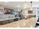 Stylish wet bar with granite countertop, stainless steel refrigerator, and floating shelves, great for entertaining at 12371 Red Fox Way, Broomfield, CO 80021