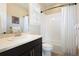 Clean bathroom featuring a shower-tub combo, white tile, and a modern vanity with ample lighting at 12371 Red Fox Way, Broomfield, CO 80021