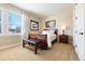 Cozy bedroom with neutral colors, a comfortable bed, and natural light streaming through the shuttered windows at 12371 Red Fox Way, Broomfield, CO 80021