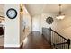 Welcoming foyer with hardwood floors, elegant lighting, and staircase leading to the upper level at 12371 Red Fox Way, Broomfield, CO 80021