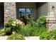 Landscaped front yard featuring a colorful garden with flowers and lush greenery at 12371 Red Fox Way, Broomfield, CO 80021