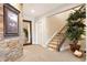 Inviting hallway featuring a staircase, decorative accents, and a mirror that enhances the sense of space at 12371 Red Fox Way, Broomfield, CO 80021