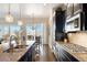 Stylish kitchen with granite counters, modern appliances, and an adjacent dining area with natural light at 12371 Red Fox Way, Broomfield, CO 80021