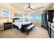 Serene main bedroom with a tray ceiling, a ceiling fan, and large windows offering scenic views at 12371 Red Fox Way, Broomfield, CO 80021