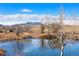 Scenic view of pond and landscape in the distance at 12371 Red Fox Way, Broomfield, CO 80021