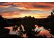 Scenic sunset view overlooking a tranquil pond reflecting vibrant colors, creating a peaceful atmosphere at 12371 Red Fox Way, Broomfield, CO 80021