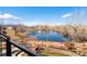 Beautiful pond view from the backyard, featuring a split rail fence and mountain views in the background at 12371 Red Fox Way, Broomfield, CO 80021