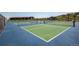 Outdoor tennis and pickleball courts offer a recreational space for residents with an attractive community building nearby at 12371 Red Fox Way, Broomfield, CO 80021