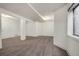 Finished basement with neutral carpet, white walls, and pillars with a window at 2062 S Xenia Way, Denver, CO 80231