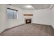 Finished basement area featuring a fireplace, neutral carpet, and a window at 2062 S Xenia Way, Denver, CO 80231