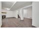 Spacious basement with neutral carpet, a fireplace, columns and a white door at 2062 S Xenia Way, Denver, CO 80231