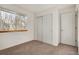 Bright bedroom features a window, closet with sliding doors, and neutral carpet at 2062 S Xenia Way, Denver, CO 80231