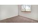 Bedroom features neutral carpet, white walls, and a window providing ample natural light at 2062 S Xenia Way, Denver, CO 80231