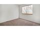 Bedroom featuring neutral carpet, white walls, and a window with horizontal blinds at 2062 S Xenia Way, Denver, CO 80231