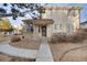 Charming two-story home with brick and vinyl siding, featuring a welcoming front porch and landscaped front yard at 2062 S Xenia Way, Denver, CO 80231