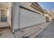 Attached two car garage with white garage door and dark gray entryway door at 2062 S Xenia Way, Denver, CO 80231