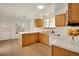 Functional kitchen featuring bright white countertops and light wood cabinets and a large garden window at 2062 S Xenia Way, Denver, CO 80231