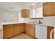 Bright kitchen with white countertops, wood cabinets, and light wood flooring at 2062 S Xenia Way, Denver, CO 80231