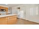 Bright kitchen with wood cabinets, an island, and vinyl floor illuminated by natural sunlight at 2062 S Xenia Way, Denver, CO 80231