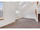 Bright living room with vaulted ceilings, skylights, neutral carpet, and large windows at 2062 S Xenia Way, Denver, CO 80231