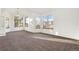 Large living room featuring neutral carpet, bright windows, and chandelier at 2062 S Xenia Way, Denver, CO 80231