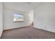 Spacious main bedroom with ceiling fan, carpet, and a partial view of the bathroom at 2062 S Xenia Way, Denver, CO 80231