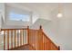 Staircase with wood railing and view of landing window at 2062 S Xenia Way, Denver, CO 80231