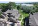 Aerial view of a community with views of a lake, pool, clubhouse, trail and well-kept lawn at 10652 W Florida Ave # D, Lakewood, CO 80232